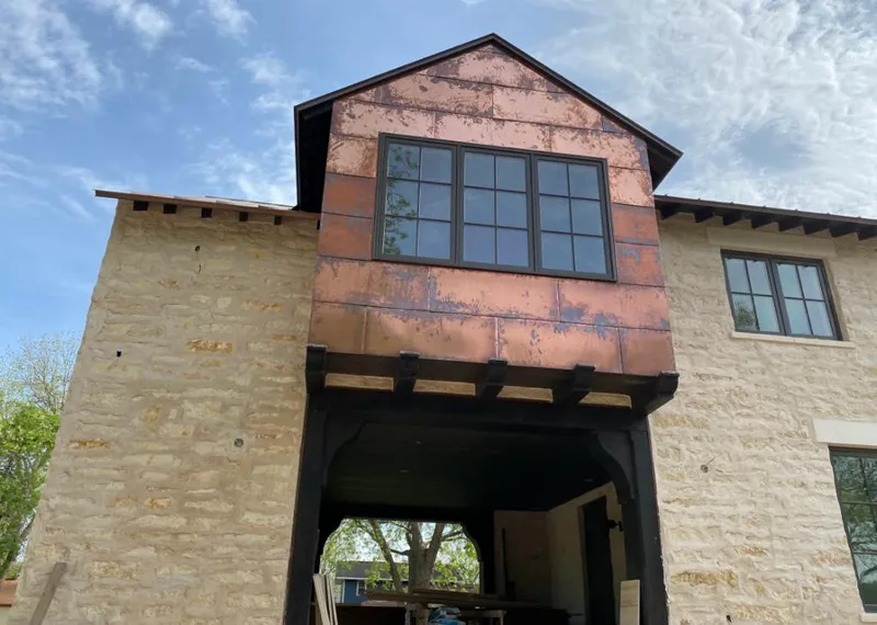 Copper metal panel facade on a stone building for Metal Roof Coating in Byram